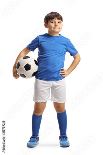 Boy in sports jersey holding a soccer ball and posing