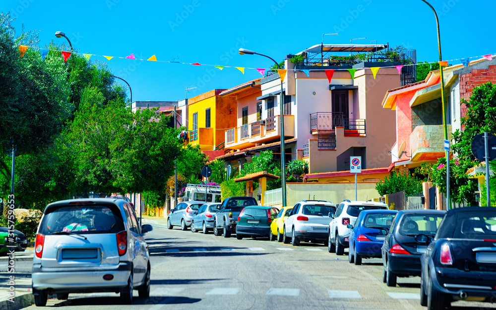 Obraz premium Street Cityscape of car road at Cagliari city at the Mediterranean Sea in South Sardinia in Italy. Sardinian Italian small town in Sardegna. Urban district. Province. Mixed media.