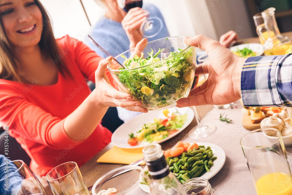 Beautiful girl holding a dish with a salad and laughing Beautiful girl holding a dish with a salad and laughing