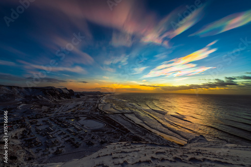 Polar stratospheric clouds during sunrise. Coastline top view. January 2020, Vik, Iceland.