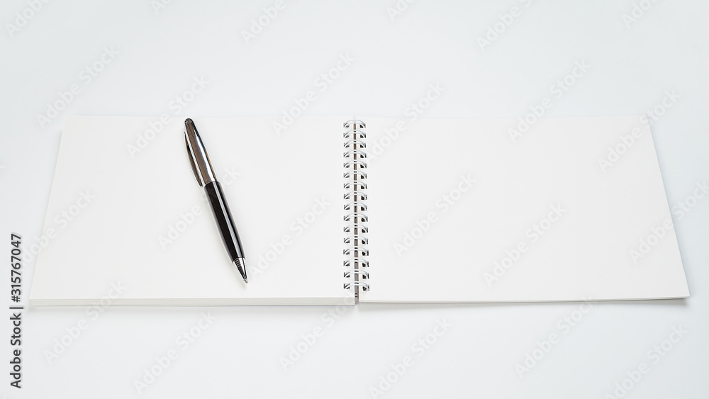 white office Desk top view with Notepad and pen,minimalistic design,top view,copy space,flat lay white office Desk top view with Notepad and pen,minimalistic design,top view,copy space,flat lay