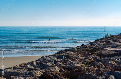 Men surfing in the Mediterranean Sea