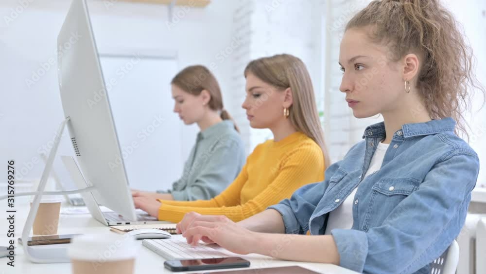 Attractive Female Startup Team Working on Computer Attractive Female Startup Team Working on Computer