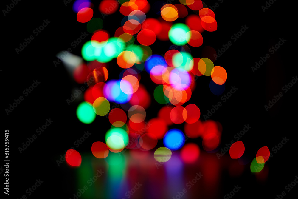 Red and orange, green, blue holliday bokeh. Abstract background