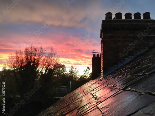 sunrise over rooftops of terrace houses in Manchester, England