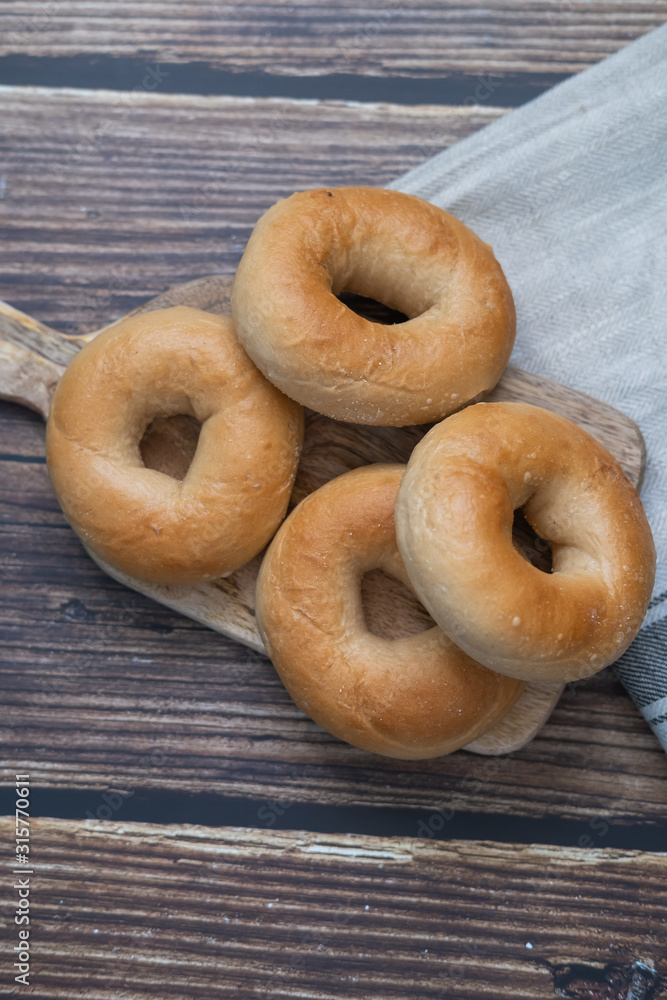 Bagels on a wooden table. Top view. Vertical picture. Bagels on a wooden table. Top view. Vertical picture.