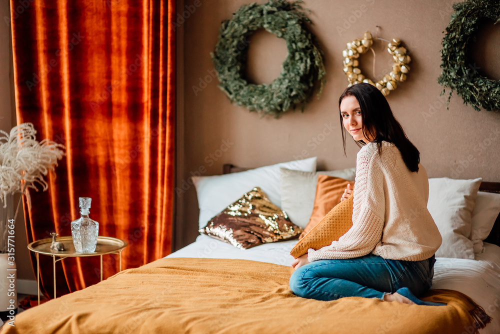 portrait of beautiful young girl indoors, lovely woman sitting on the bed at home portrait of beautiful young girl indoors, lovely woman sitting on the bed at home