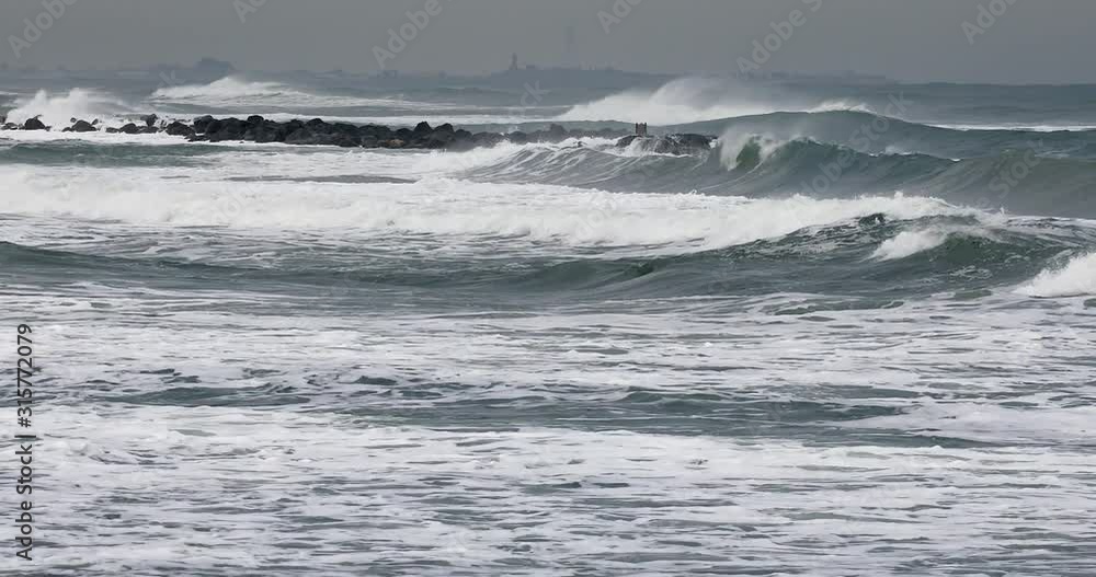Waves shattering in a breakwater on a stormy sea. Waves shattering in a breakwater on a stormy sea.