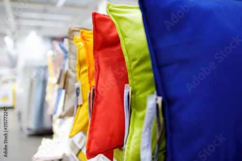 Variety of colour pillows on shopping stand in supermarket