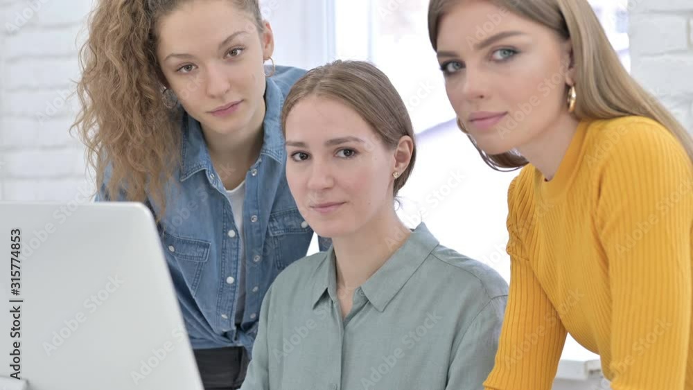 Serious Young Female Designers Looking at the Camera Serious Young Female Designers Looking at the Camera