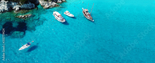 Aerial drone ultra wide photo of sailing yacht docked in paradise turquoise sea exotic island destination