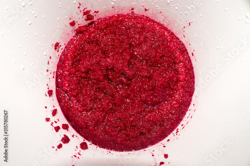 Beets ground in a blender.The texture of mashed beets.Background of grated beetroot.
