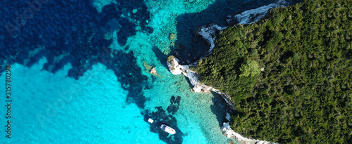 Aerial drone ultra wide photo of paradise tropical exotic white rocky deep turquoise seascape forming a blue lagoon in Caribbean popular destination © aerial-drone