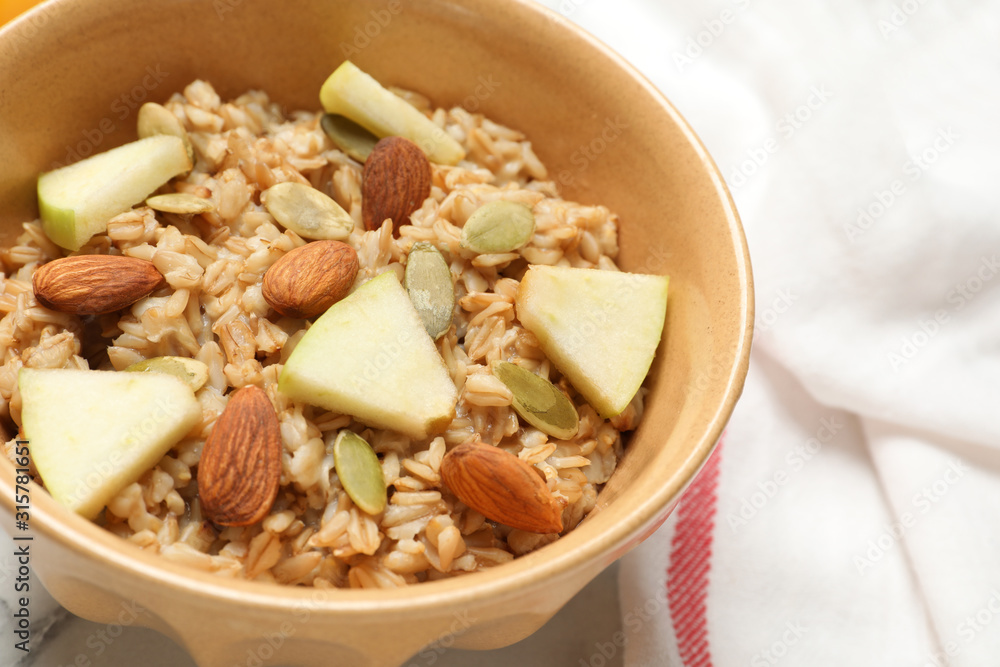 Tasty oatmeal with apples and almonds on table, closeup. Healthy breakfast Tasty oatmeal with apples and almonds on table, closeup. Healthy breakfast