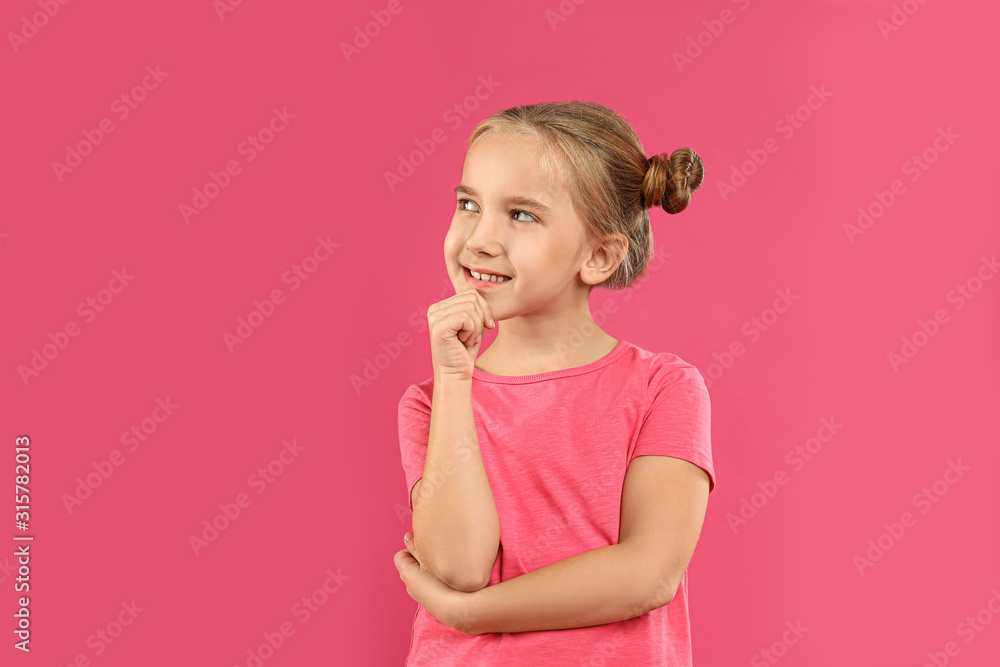 Cute little girl posing on pink background Cute little girl posing on pink background