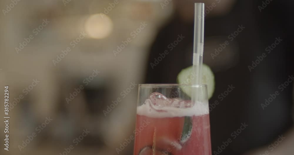 Making lemonads on the bar in the restaurant. Process of making a lemonades by the bartender at the bar. Non alcoholic cocktail with ice and decoration. Soft focus and beautiful bokeh. Making lemonads on the bar in the restaurant. Process of making a lemonades by the bartender at the bar. Non alcoholic cocktail with ice and decoration. Soft focus and beautiful bokeh.