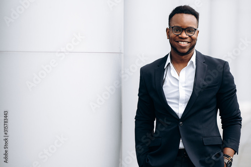 Konstfotografi Smiling handsome  african american man in stylish formal suit, outdoors