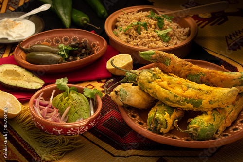 Traditional mexican chiles rellenos, rice and side dishes