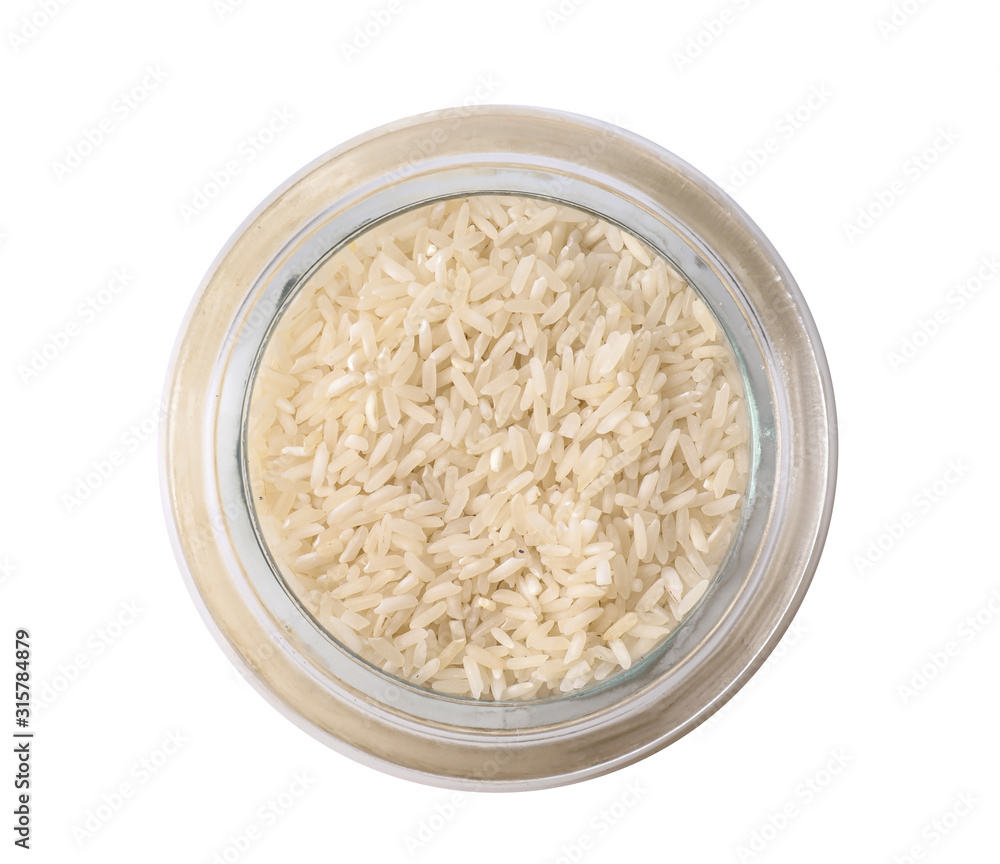 Uncooked rice in glass jar isolated on white, top view Uncooked rice in glass jar isolated on white, top view