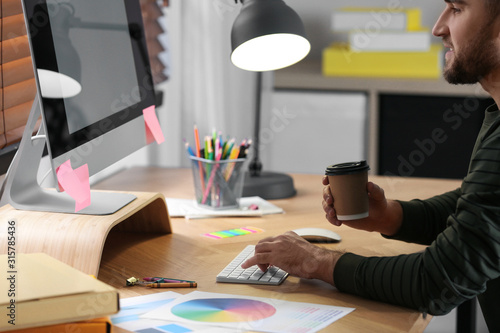 Male designer working at desk in office