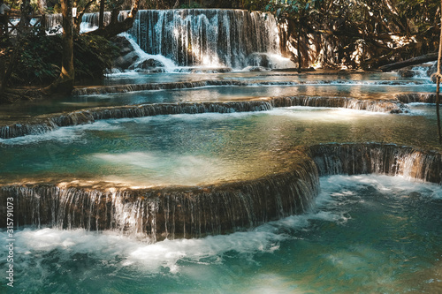 Fototapeta Naklejka Na Ścianę i Meble -  Majestic blue water flowing down multistep waterfall