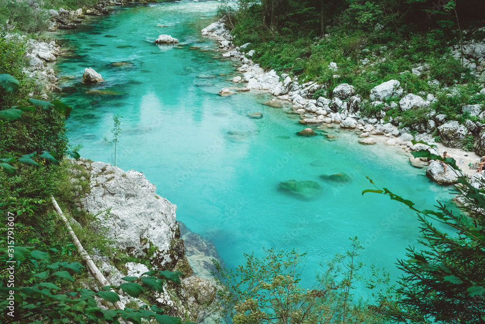 Bright clear blue river surrounded by rocky shores Bright clear blue river surrounded by rocky shores