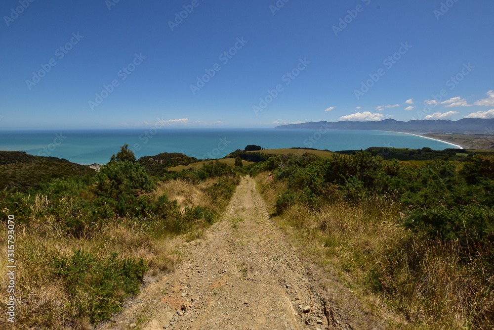 Cape Palliser bay view with gravel track in the front Cape Palliser bay view with gravel track in the front