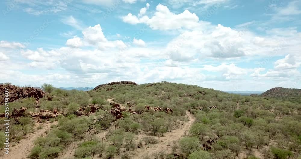Forward moving drone shot on a mountain on a dry game farm during drought near Okahandja, Namibia. Forward moving drone shot on a mountain on a dry game farm during drought near Okahandja, Namibia.