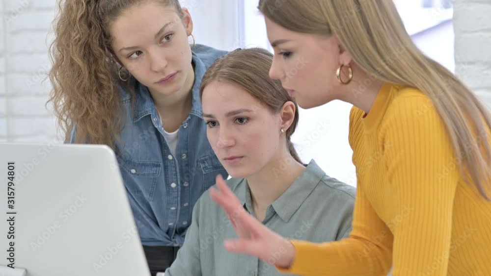 Ambitious Young Female Creative Team working on Computer Ambitious Young Female Creative Team working on Computer