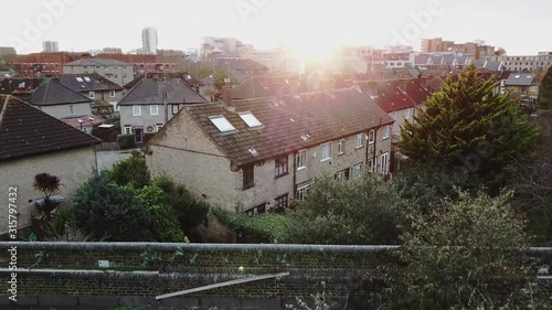 reveal shot of london thames river over the bridge in millwall during sunset photo