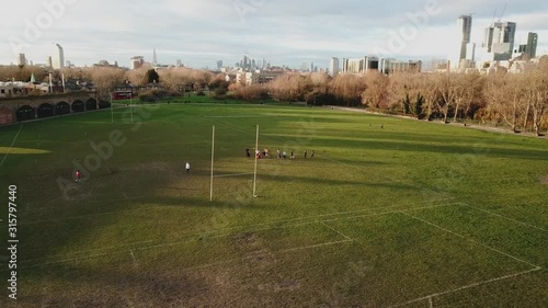 Aerial drone view of amateur women playing american football or rugby in the park photo