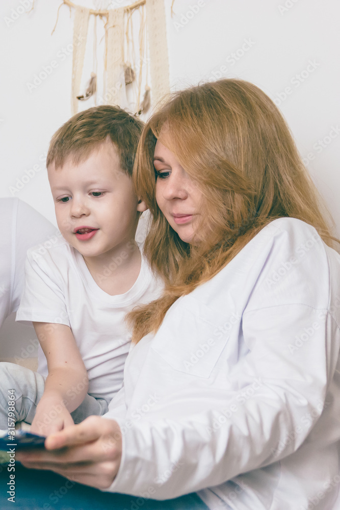 A loving mother reads with her child. Happy family concept A loving mother reads with her child. Happy family concept