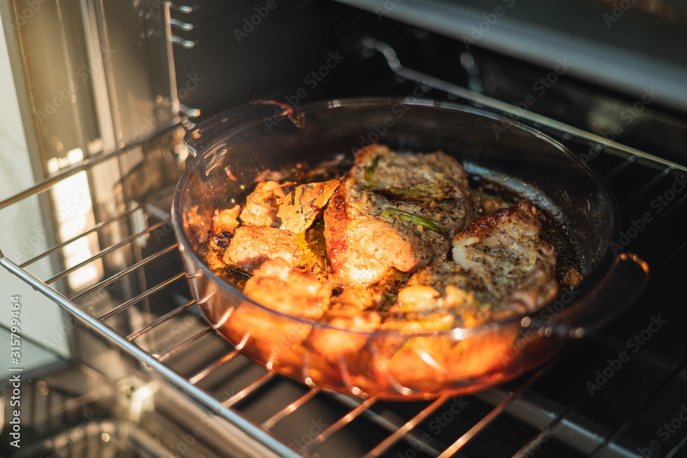 Roasted Pork oven. Housewife prepares roast meat with vegetables in the oven. Cooking in the oven. Roasted Pork oven. Housewife prepares roast meat with vegetables in the oven. Cooking in the oven.