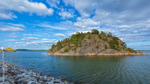 Slika na platnu Rocky island with evergreen coniferous forest in the skerries of the Turku archipelago on a sunny summer day