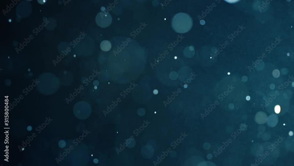 Floating abstract particle bokeh on dark background Floating abstract particle bokeh on dark background