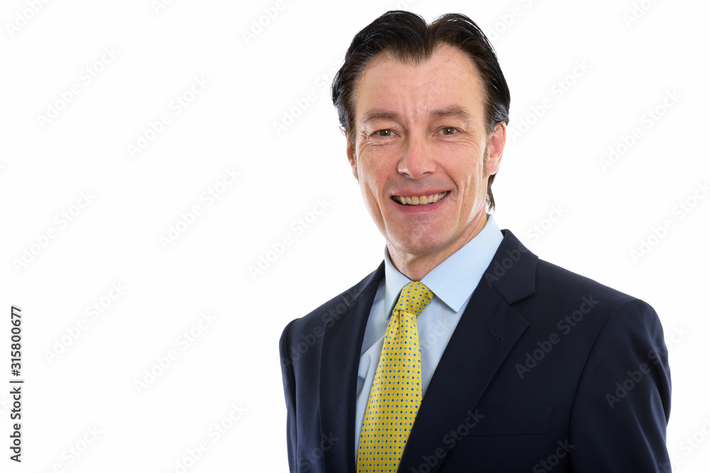 Studio shot of mature happy businessman smiling Studio shot of mature happy businessman smiling