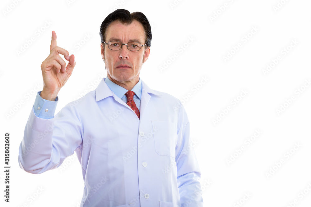Mature handsome man doctor with eyeglasses pointing up Mature handsome man doctor with eyeglasses pointing up