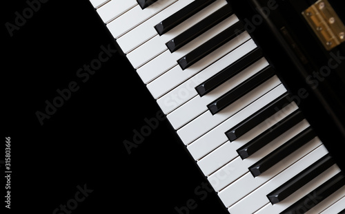 Fényképezés Piano and Piano keyboard with black background.