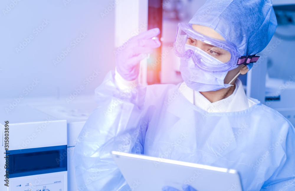 Female scientist looking at the scientific sample in the CDC laboratory. Female scientist looking at the scientific sample in the CDC laboratory.