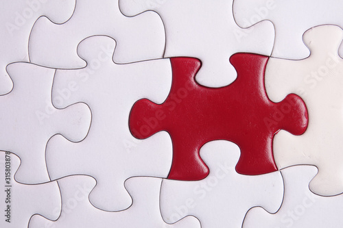 Red puzzle on white background. Copy space
