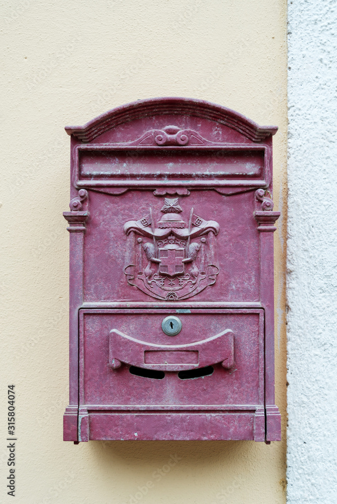 Postbox with a coat of arms in the wall in the Italian town Vernazza of the coastal area Cinque Terre