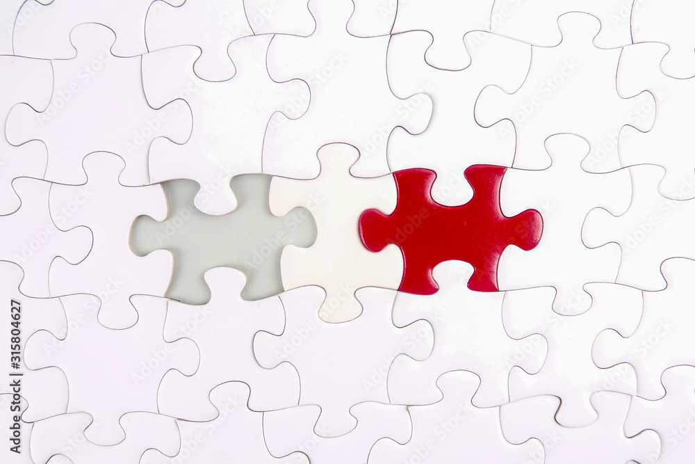 Fototapeta premium Magnifying glass searching missing puzzle.