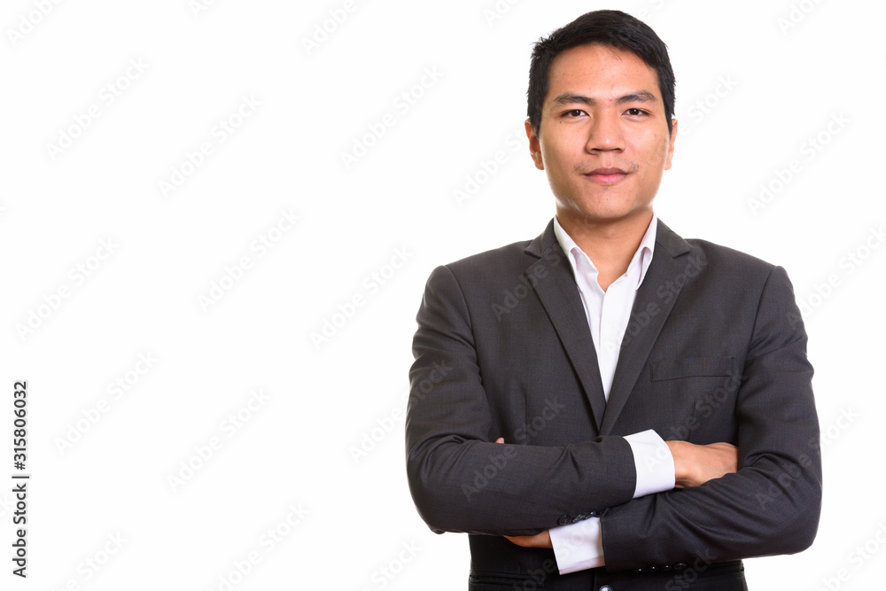 Studio shot of young Asian businessman with arms crossed Studio shot of young Asian businessman with arms crossed