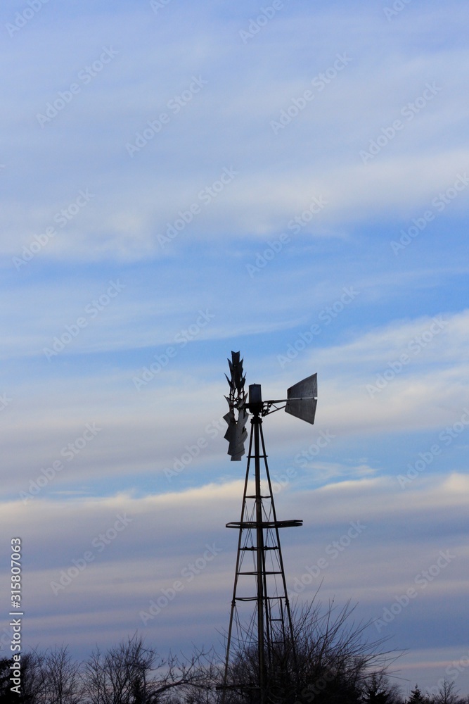 Kansas Windmill at Sunset with clouds and sky. Kansas Windmill at Sunset with clouds and sky.