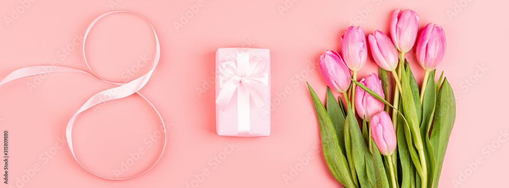 View from above tulips and gift box with copy space. Background for womens day, 8 March Valentines day, 14 february. Flat lay style, top view, mockup, template, overhead. Greeting card View from above tulips and gift box with copy space. Background for womens day, 8 March Valentines day, 14 february. Flat lay style, top view, mockup, template, overhead. Greeting card