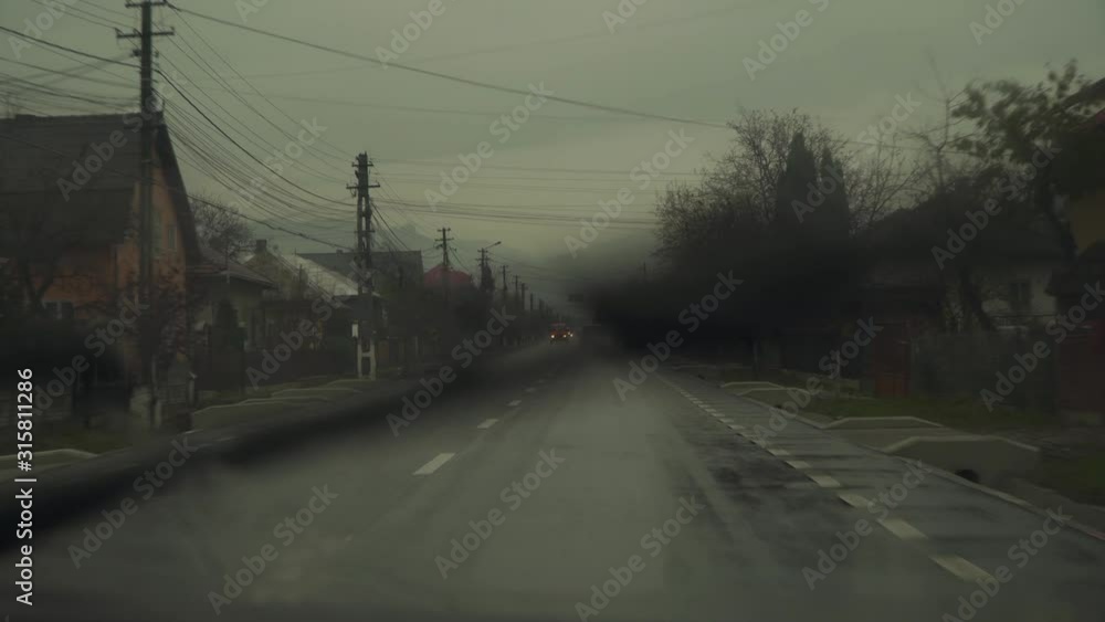 Driving A Car On A Long Narrow Road On A Rainy Day - Medium Shot Driving A Car On A Long Narrow Road On A Rainy Day - Medium Shot