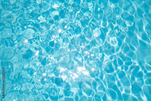 ripped water in swimming pool .surface of blue swimming pool,background of water in swimming pool. © Adil
