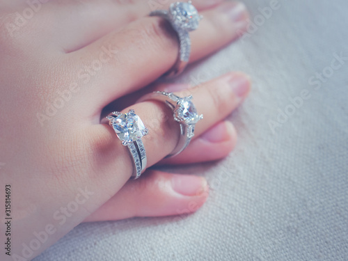 Closeup diamond ring on the finger og a beautiful girl.