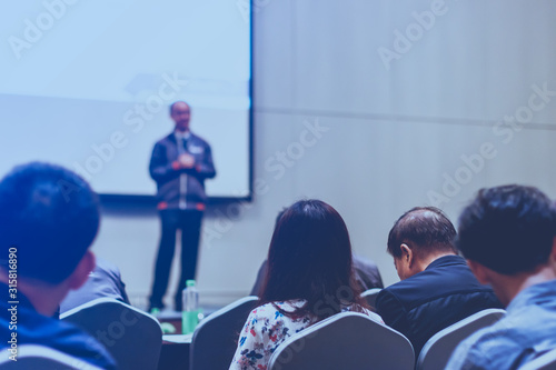 Speakers on the stage with Rear view of Audienceor seminar meeting, business and education about investment concept