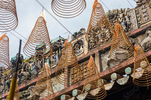 Tableau sur toile Burning spiral incense sticks hanging from the ceiling of Chua Ba Thien Hau pagoda in Ho Chi Minh, Vietnam